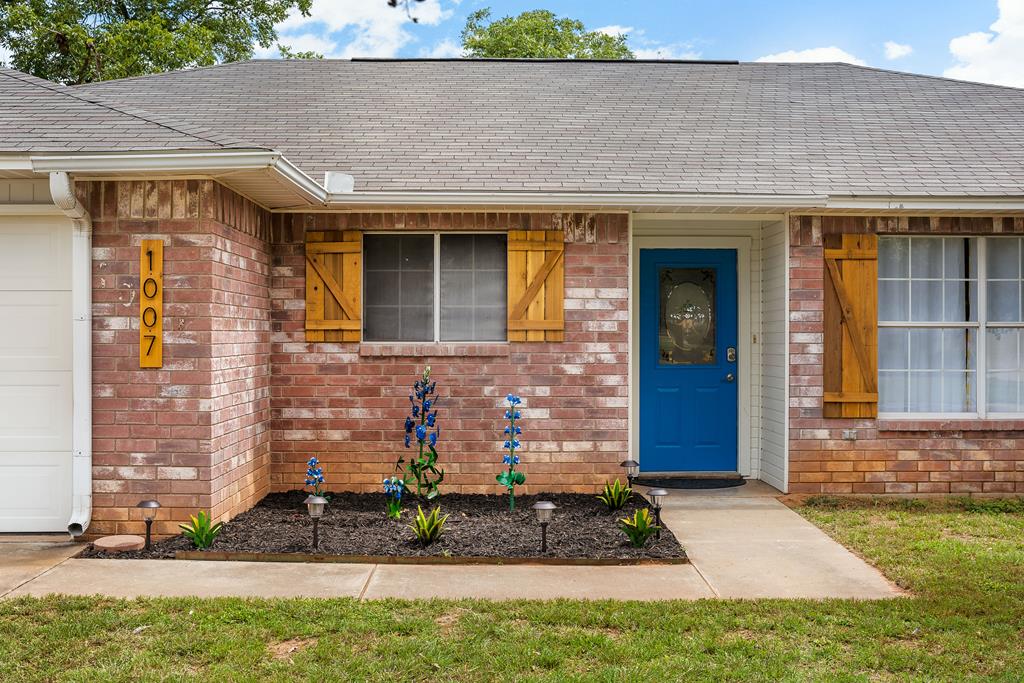 a front view of a house with garden