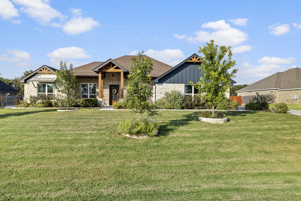 a front view of a house with a yard