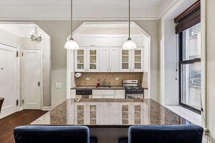 a kitchen with a table chairs window and refrigerator