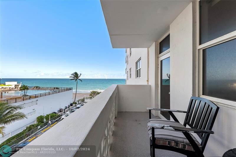 a view of a balcony with furniture