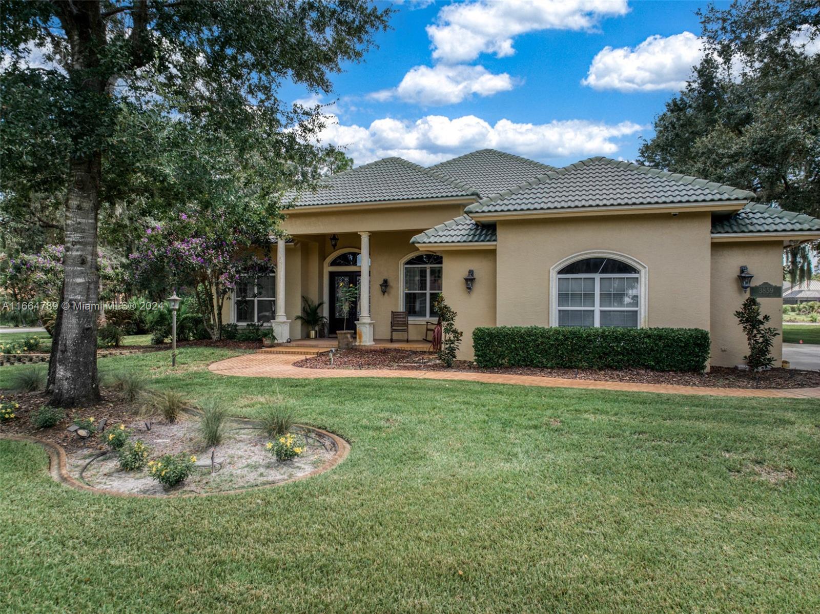 a view of a house with backyard porch and sitting area