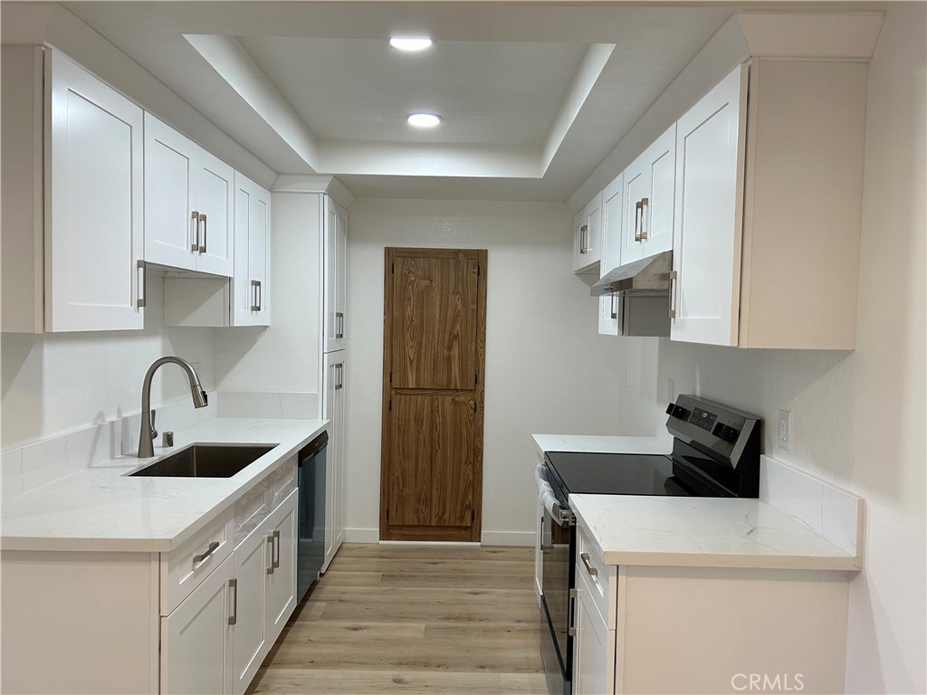 a kitchen with a sink a stove and refrigerator