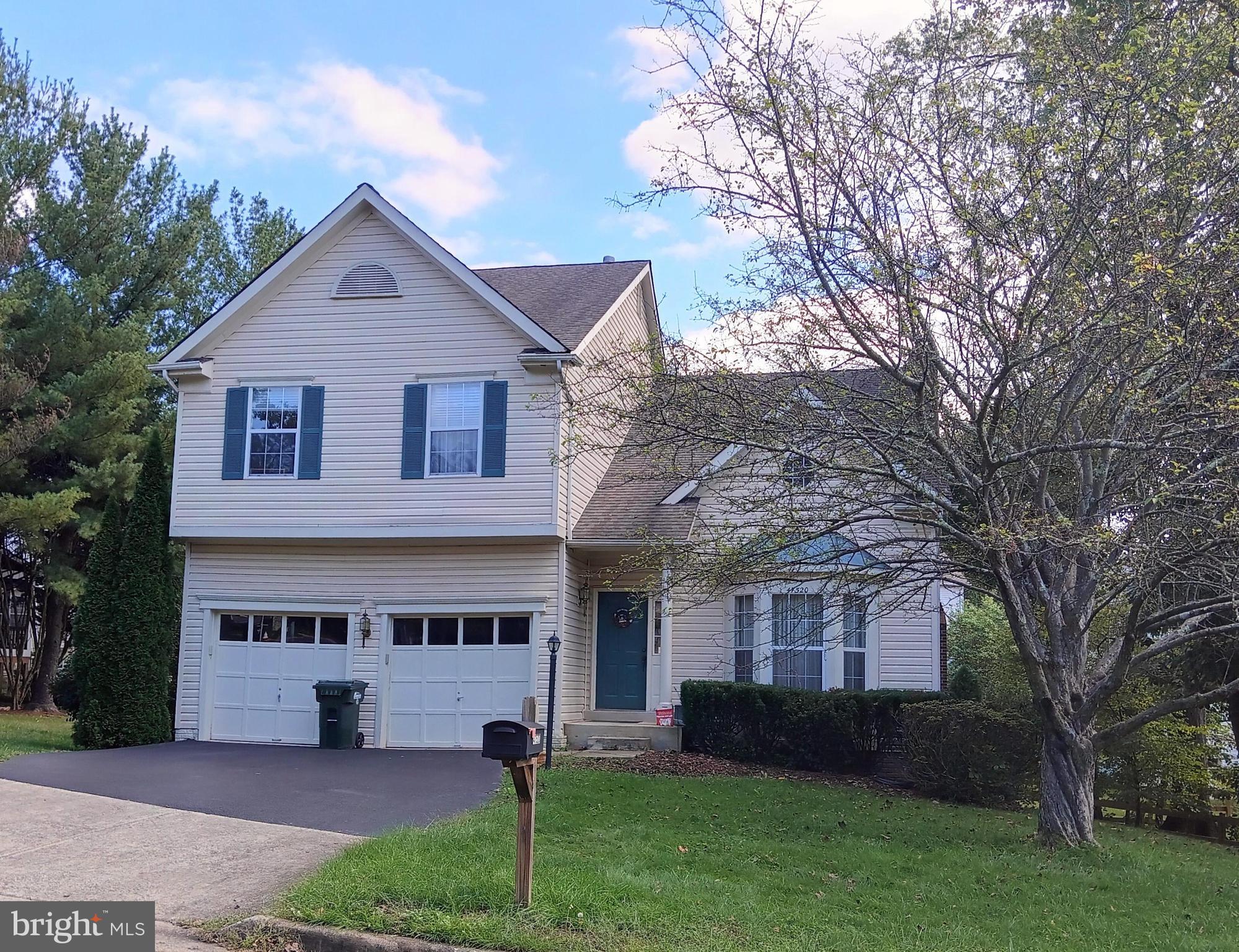 a view of house with yard and green space