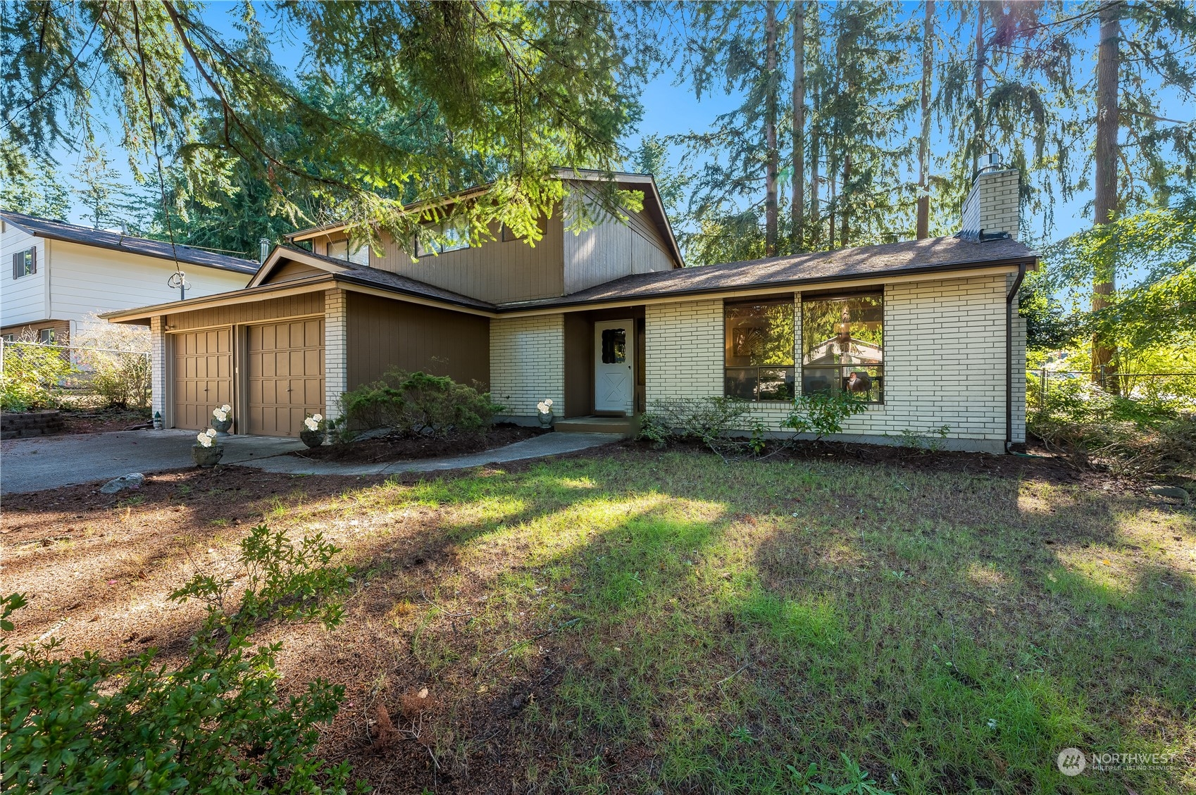 a front view of house with yard and trees around