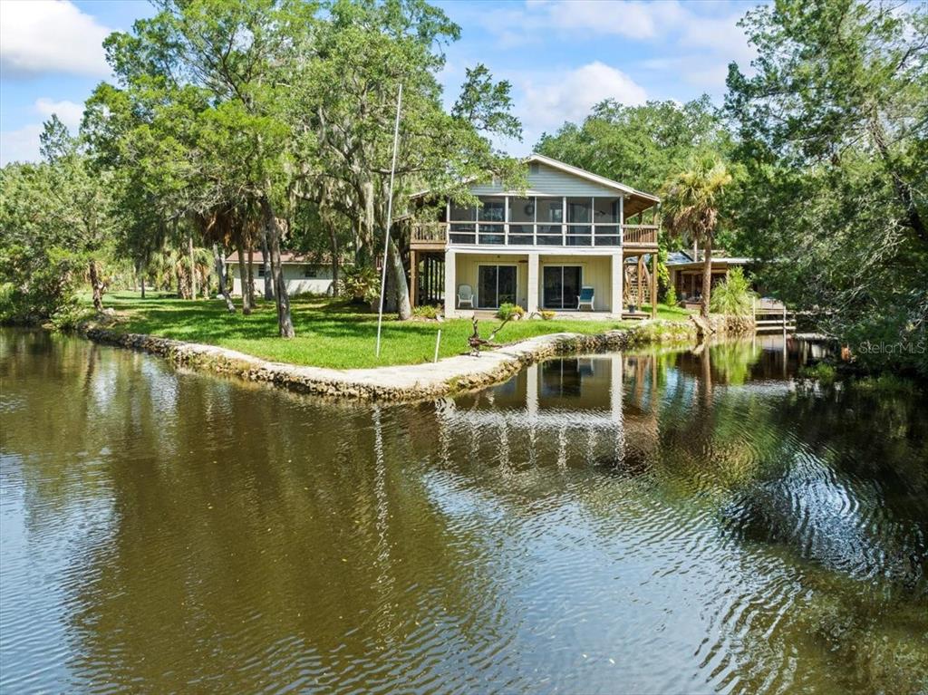 a view of a lake with a house in the background