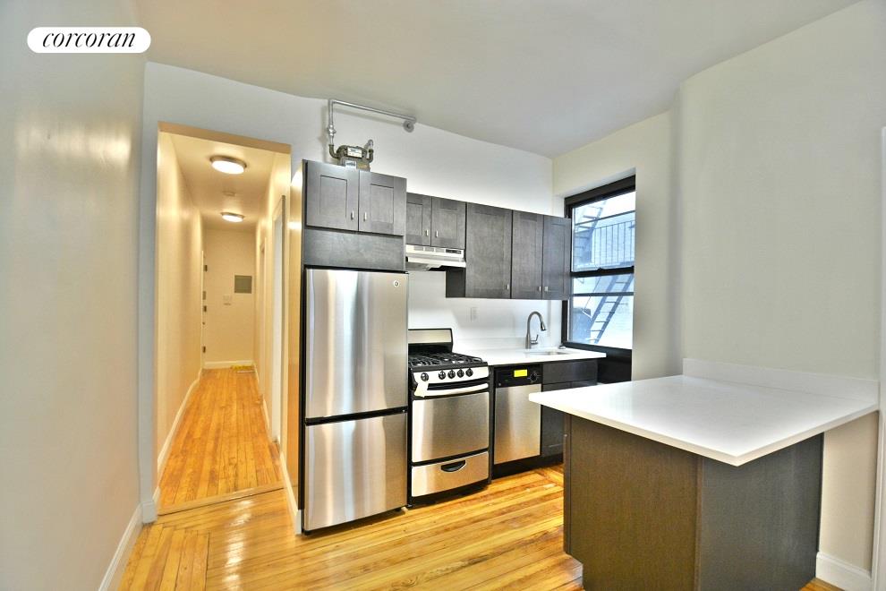 a kitchen with a refrigerator and a sink