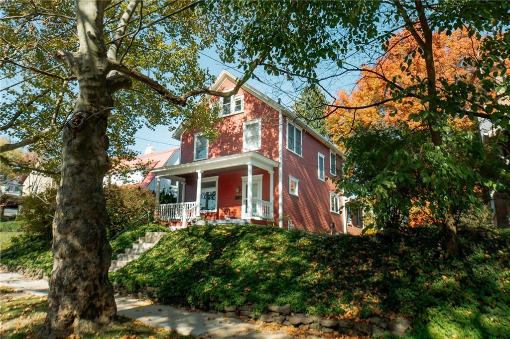 a front view of a house with a garden