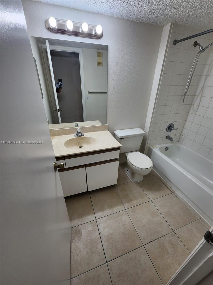 a bathroom with a sink mirror vanity and toilet