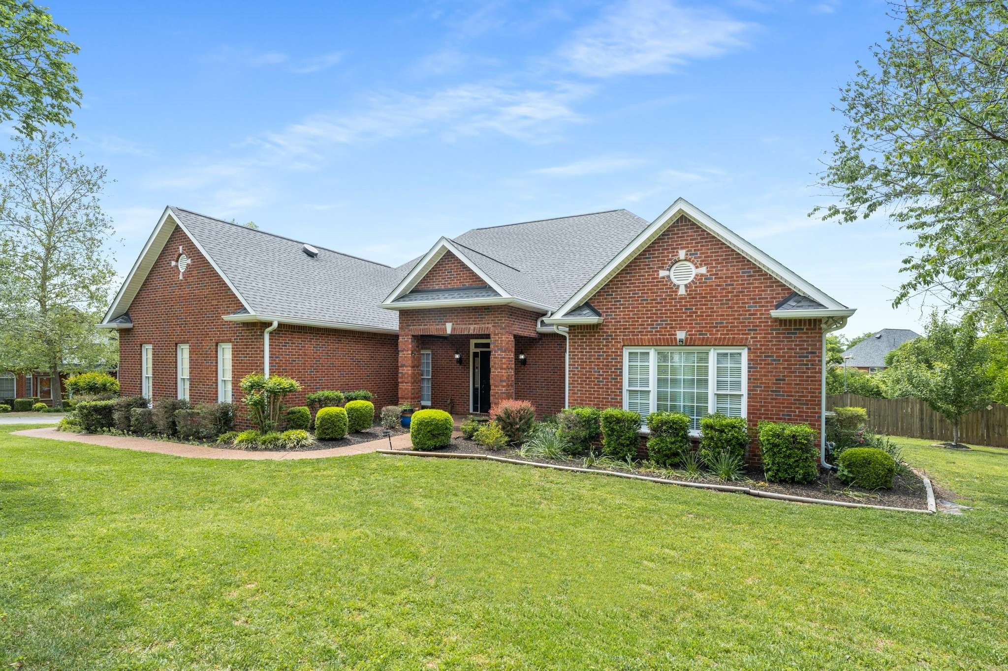 a front view of a house with a garden