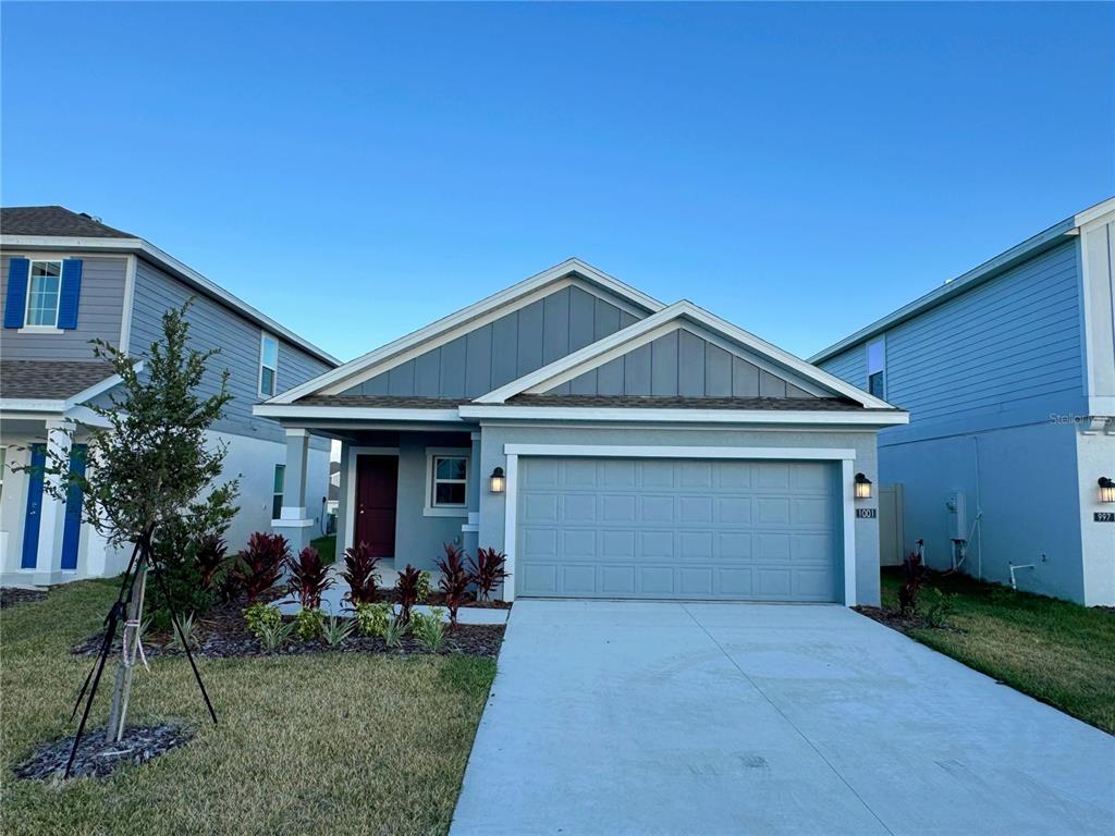 a front view of house with a yard and garage