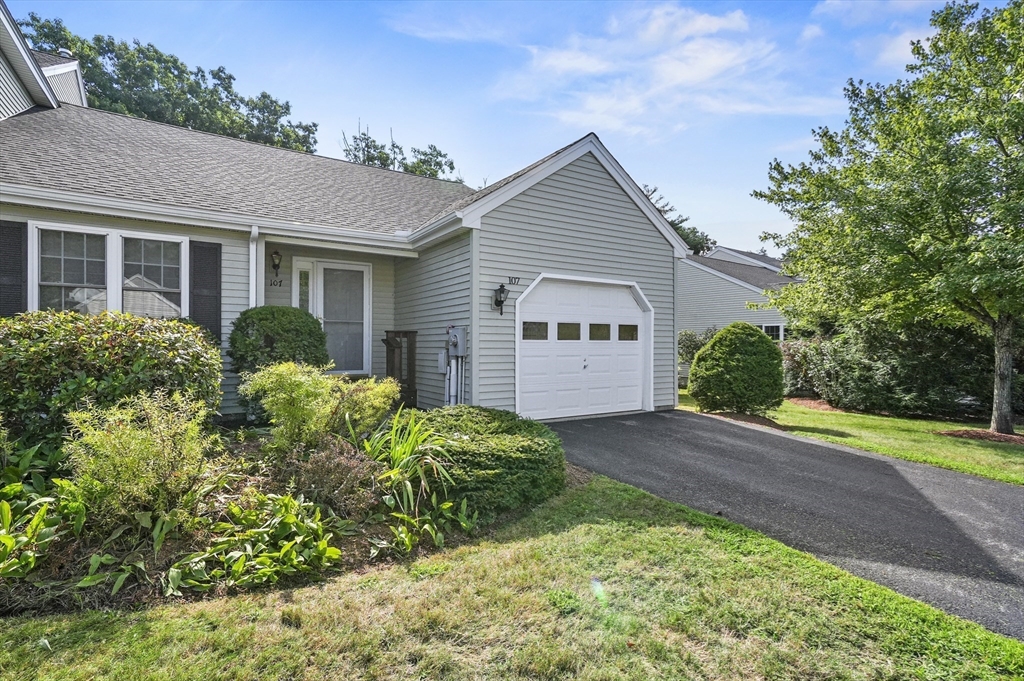 a view of a house with garden and yard