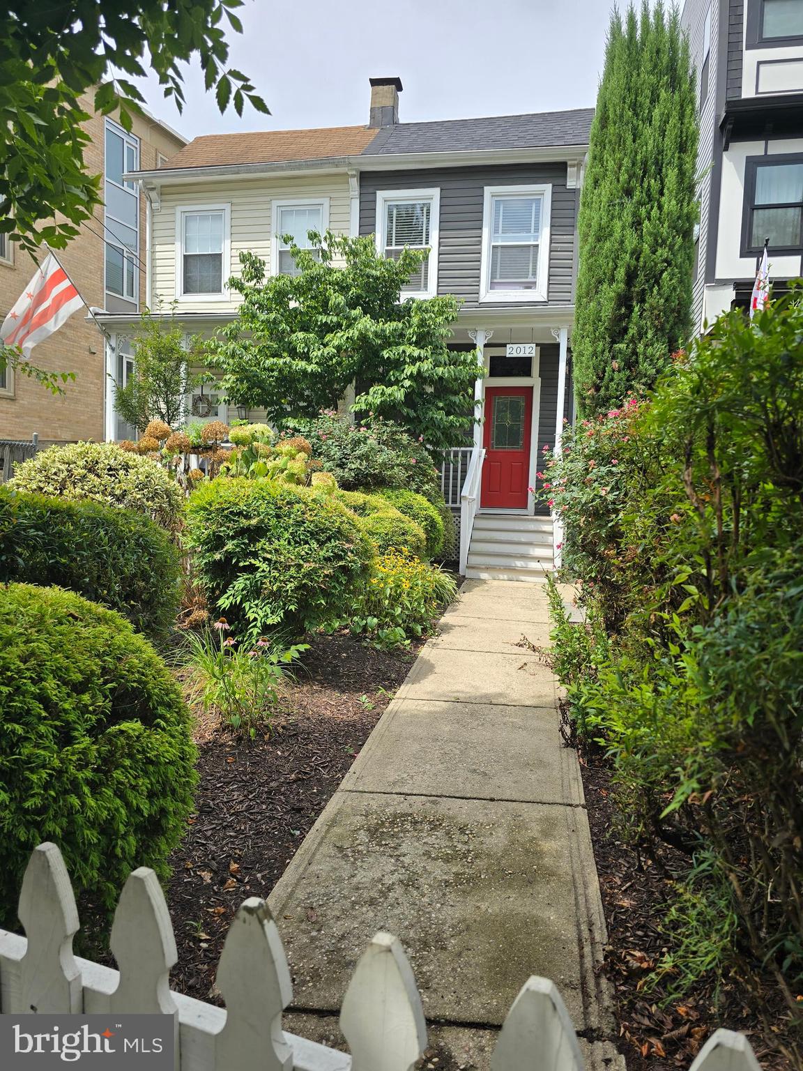 a front view of a house with garden