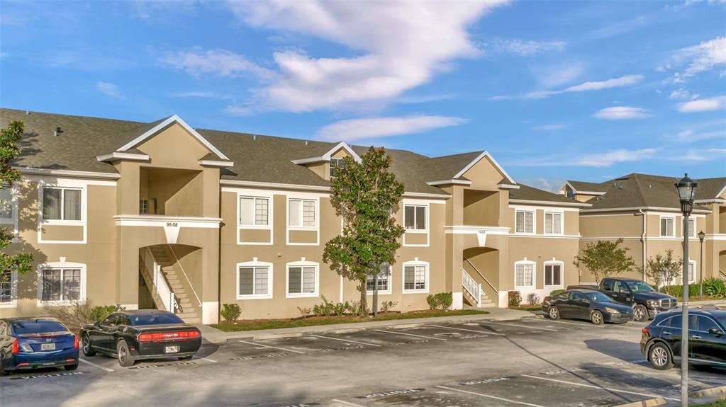 a front view of a residential apartment building with a yard