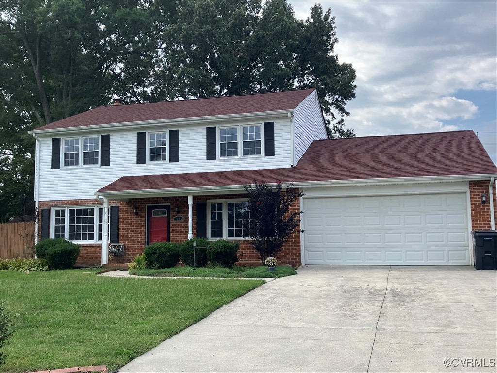 View of front facade featuring a garage and a fron