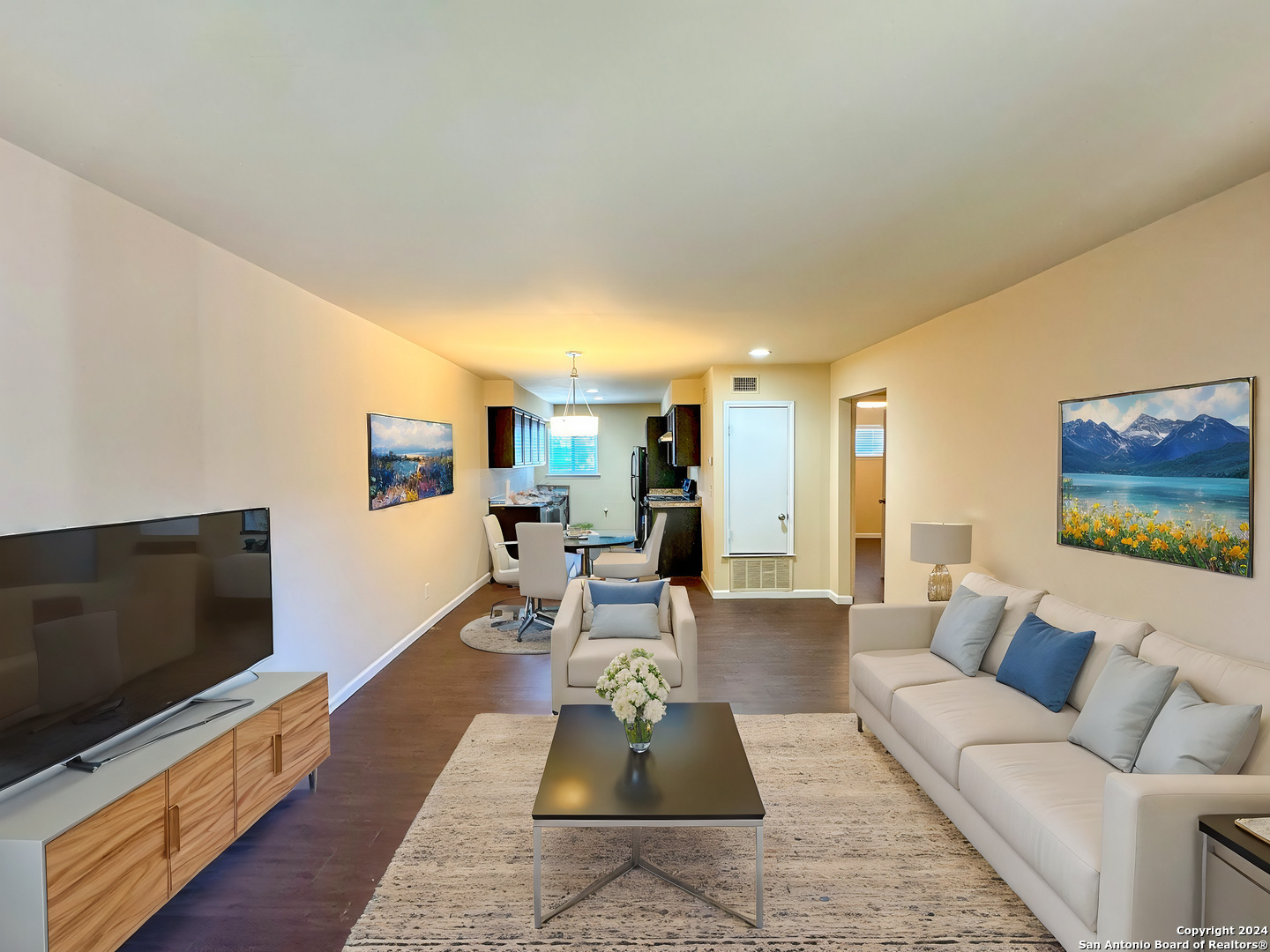 a living room with furniture and a flat screen tv