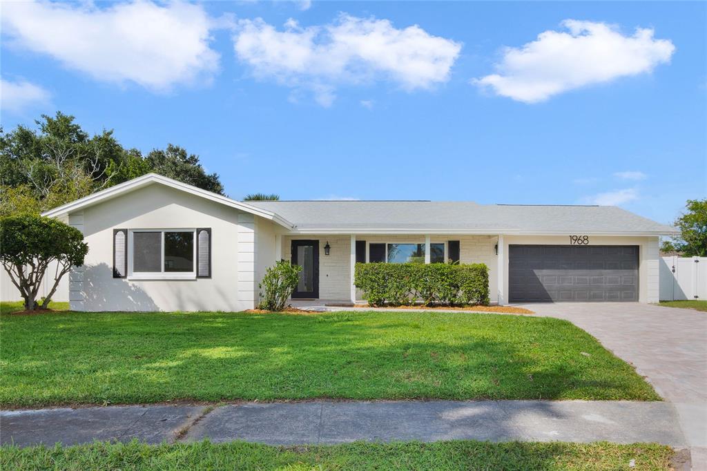 a front view of house with yard and green space