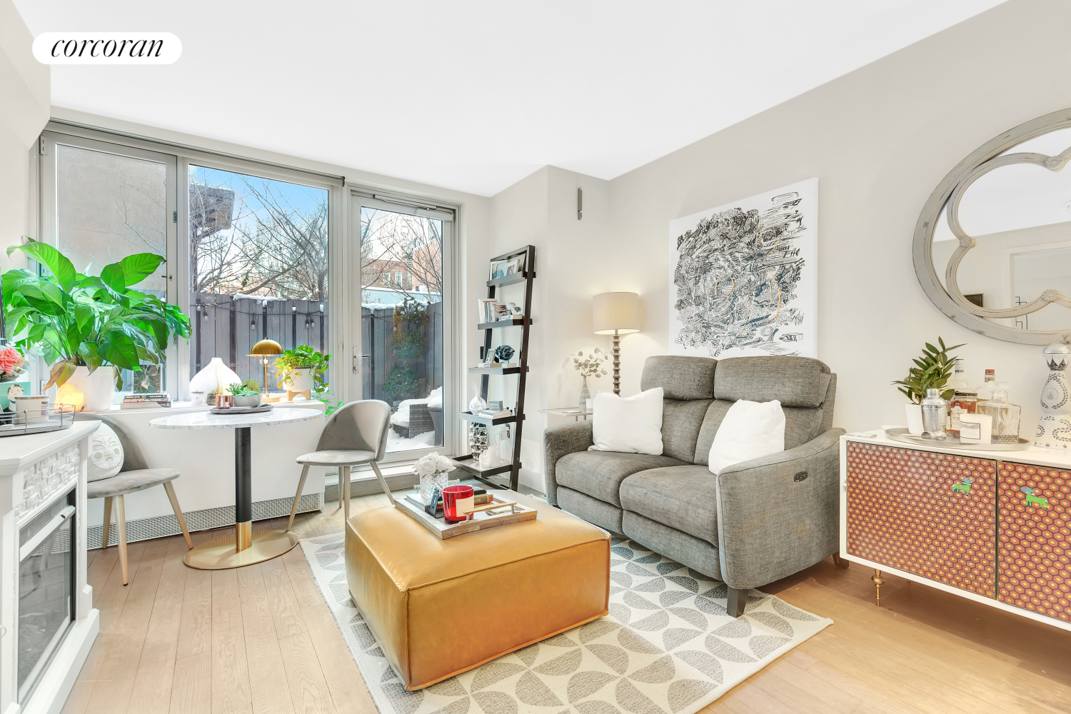 a living room with furniture a table and a potted plant