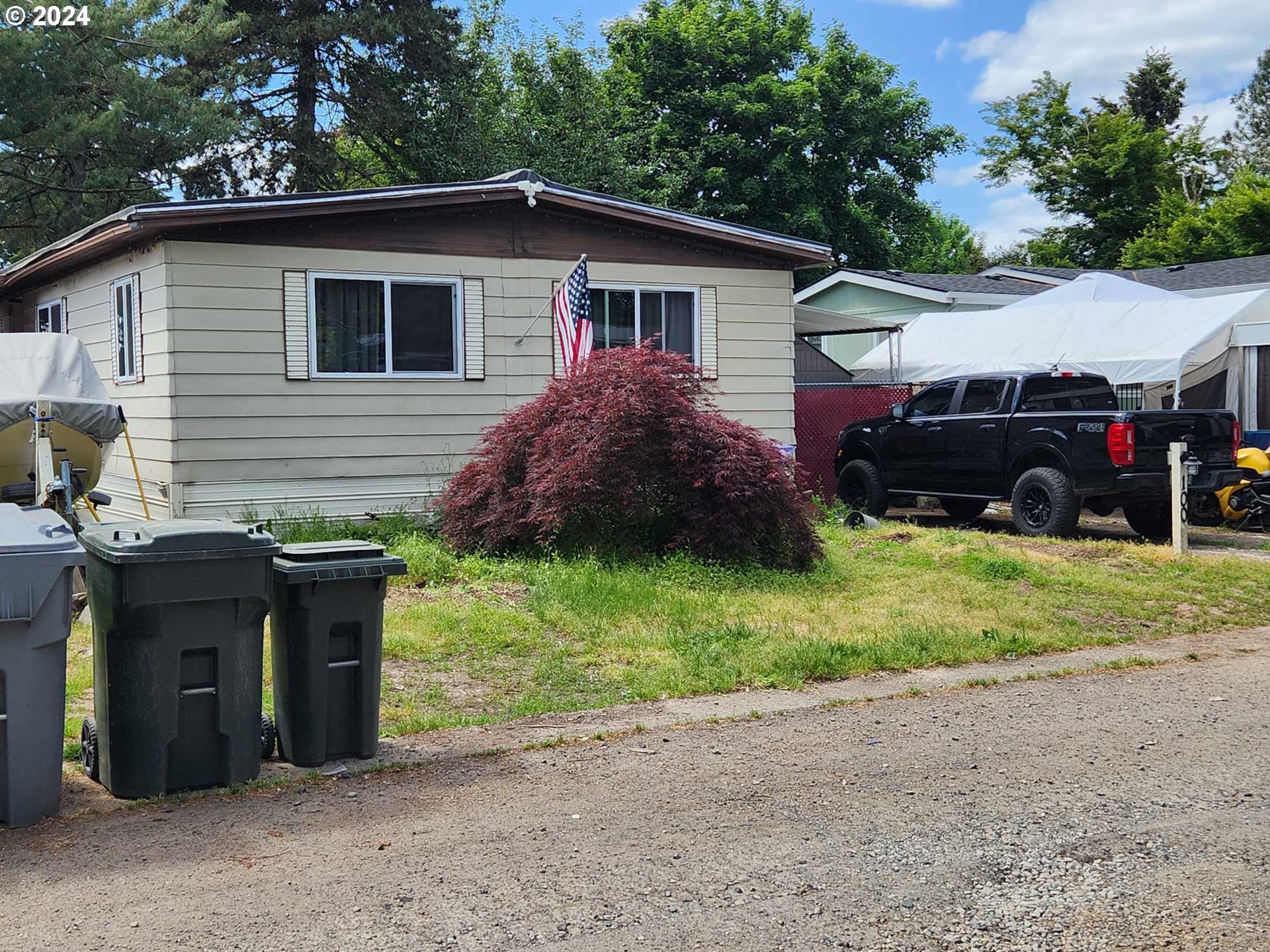 a front view of a house with a garden and plants