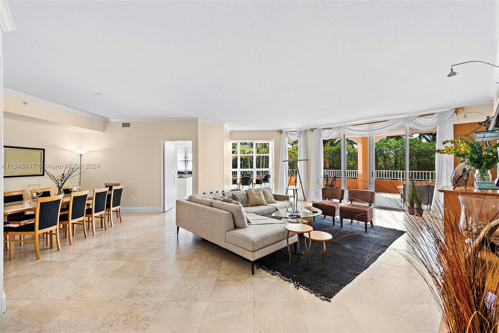 a living room with furniture and large windows