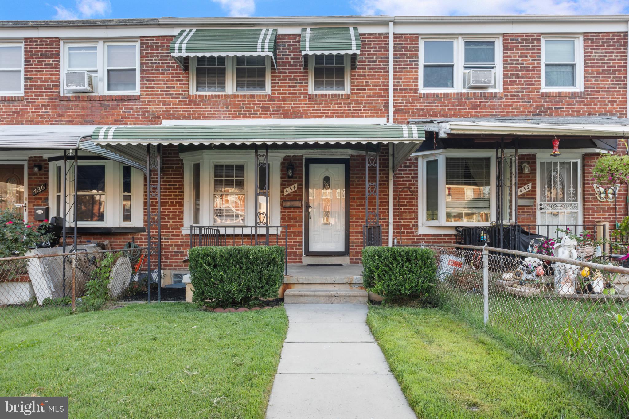 front view of a brick house with a yard