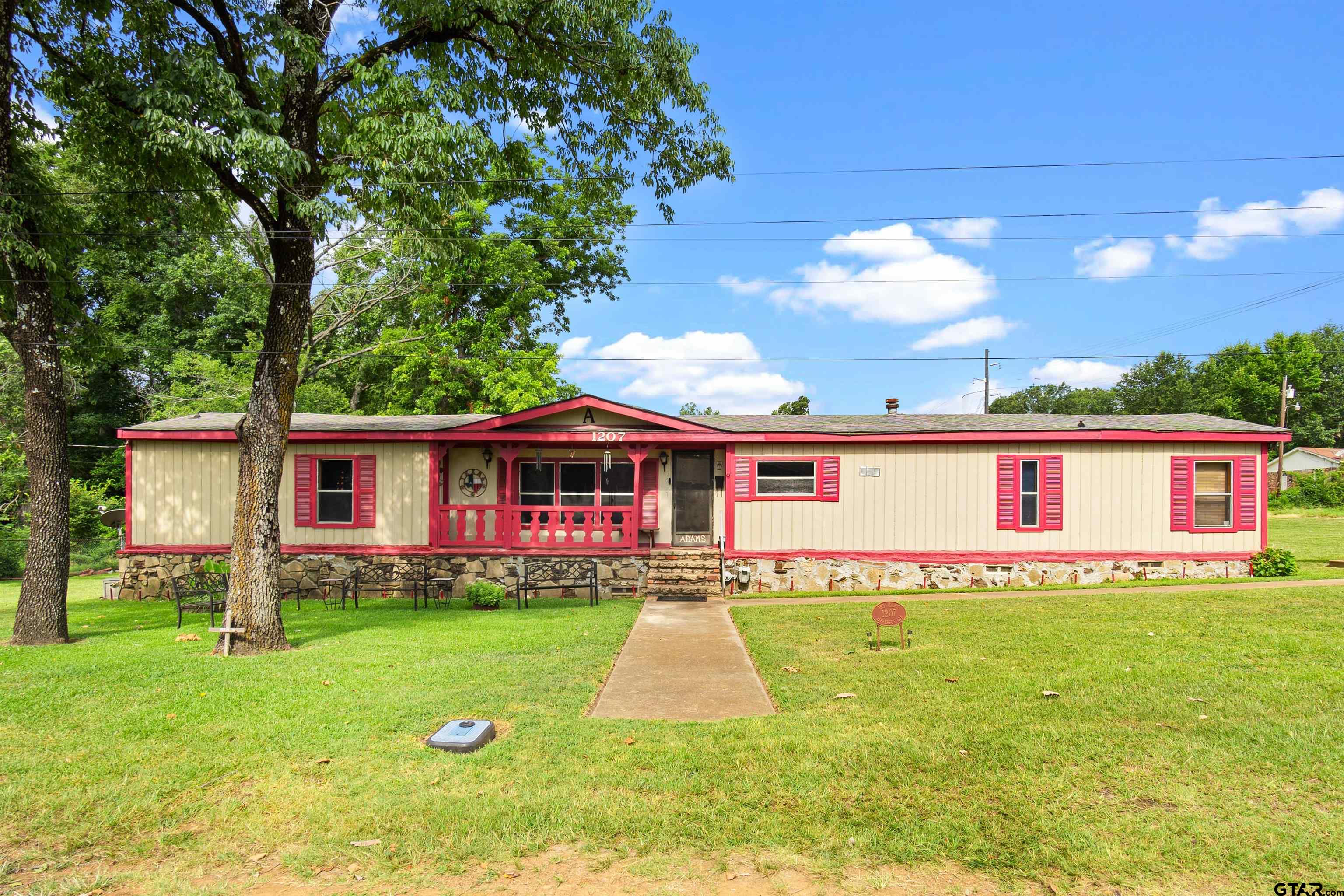 a front view of house with yard and green space