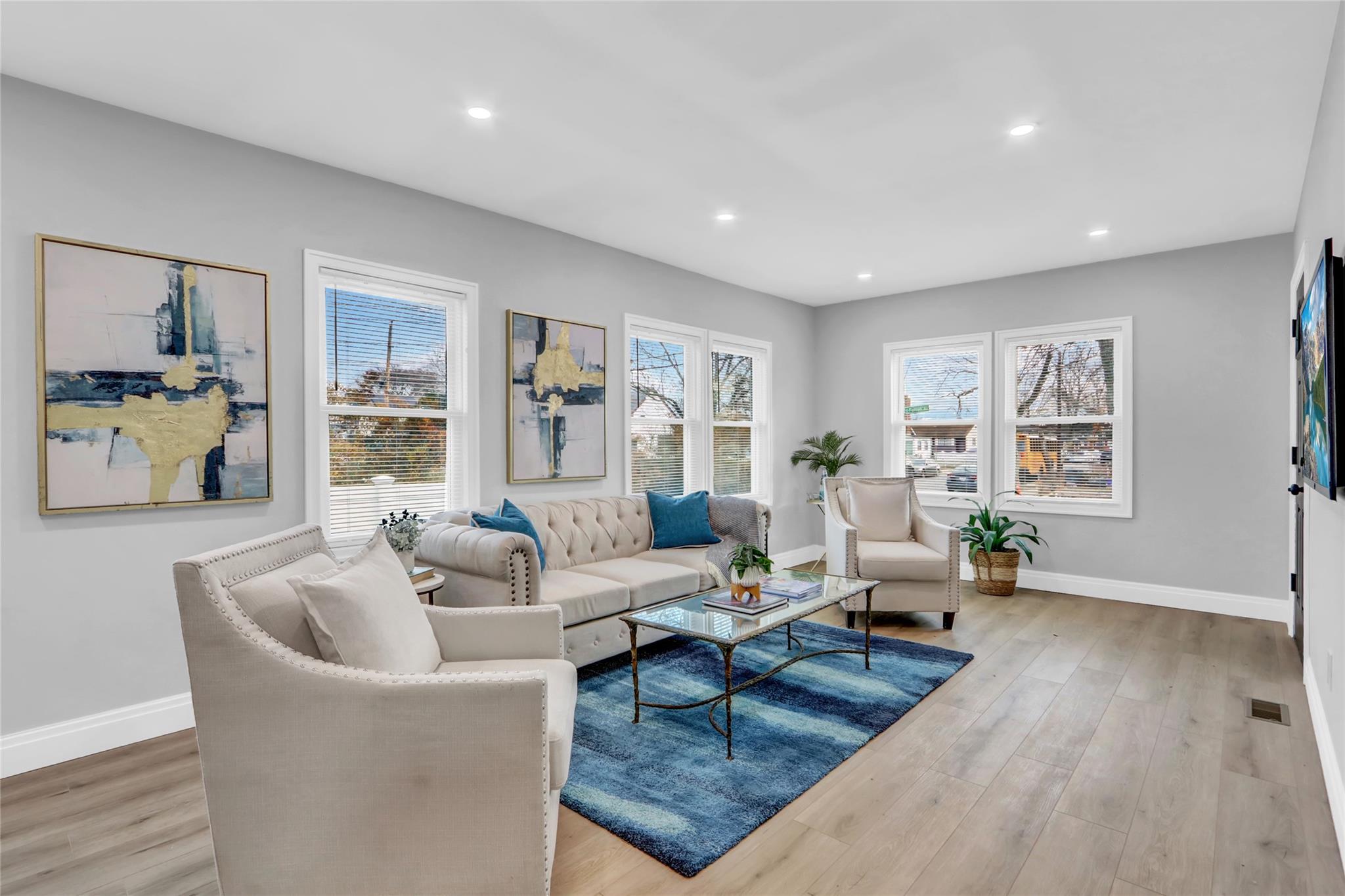 Living room with a wealth of natural light and light wood-type flooring