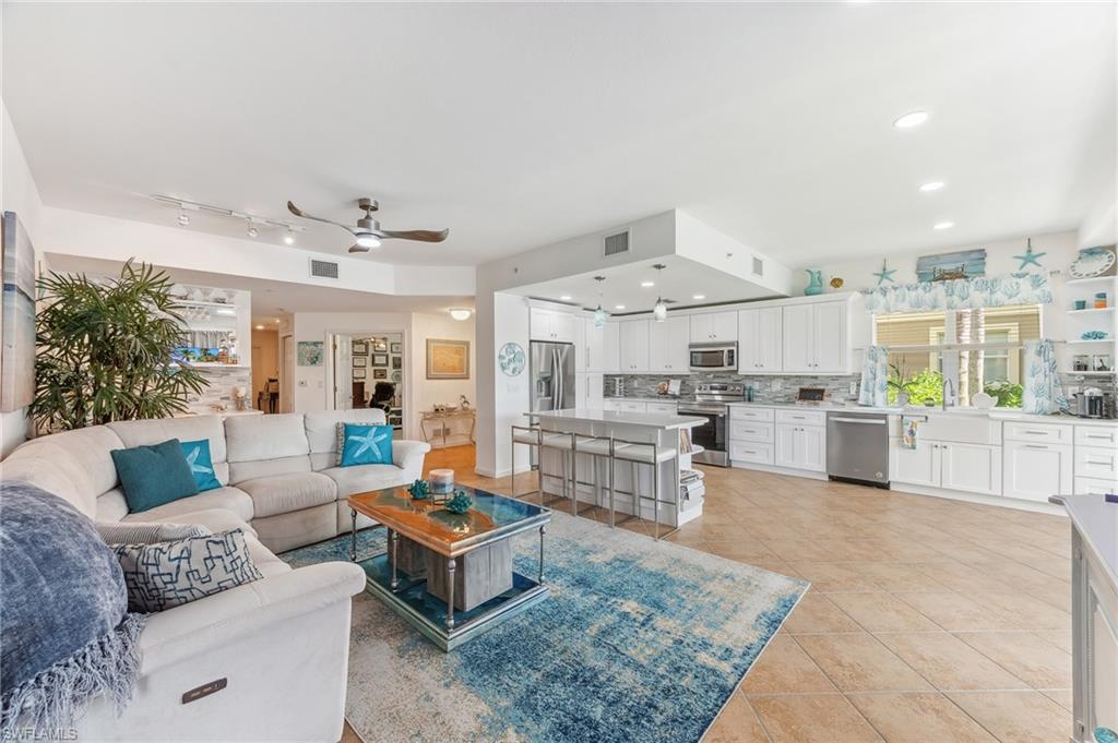 Tiled living room with sink and ceiling fan