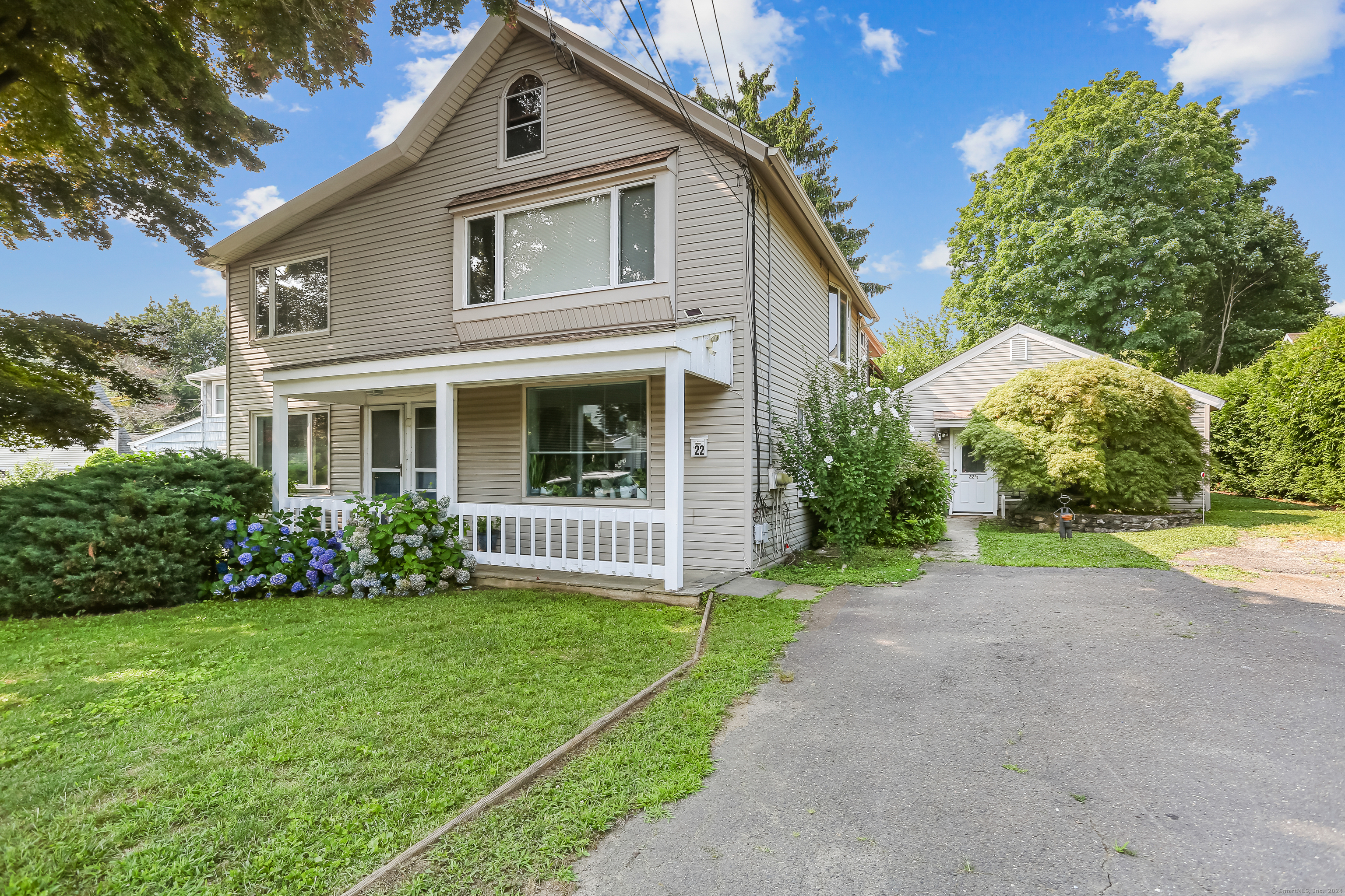 a front view of house with yard and green space