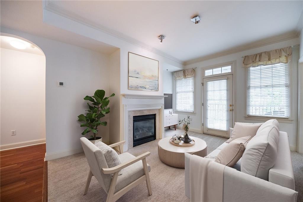 a living room with furniture potted plant and a fireplace