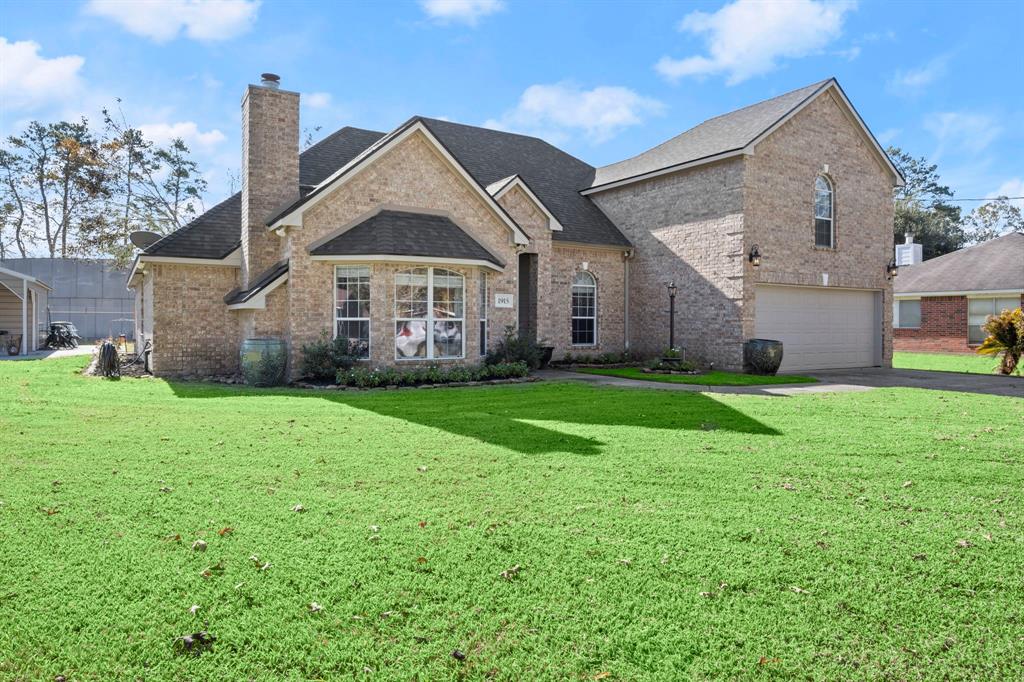 a front view of house with yard and green space