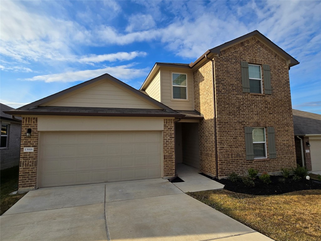 a front view of a house with a yard and garage