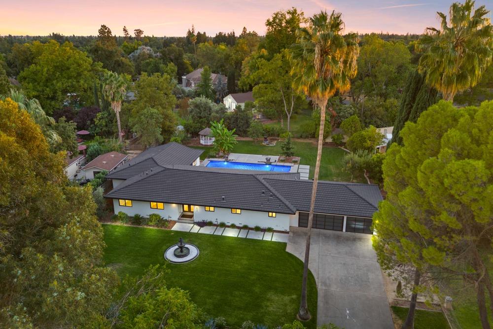 an aerial view of a house with yard