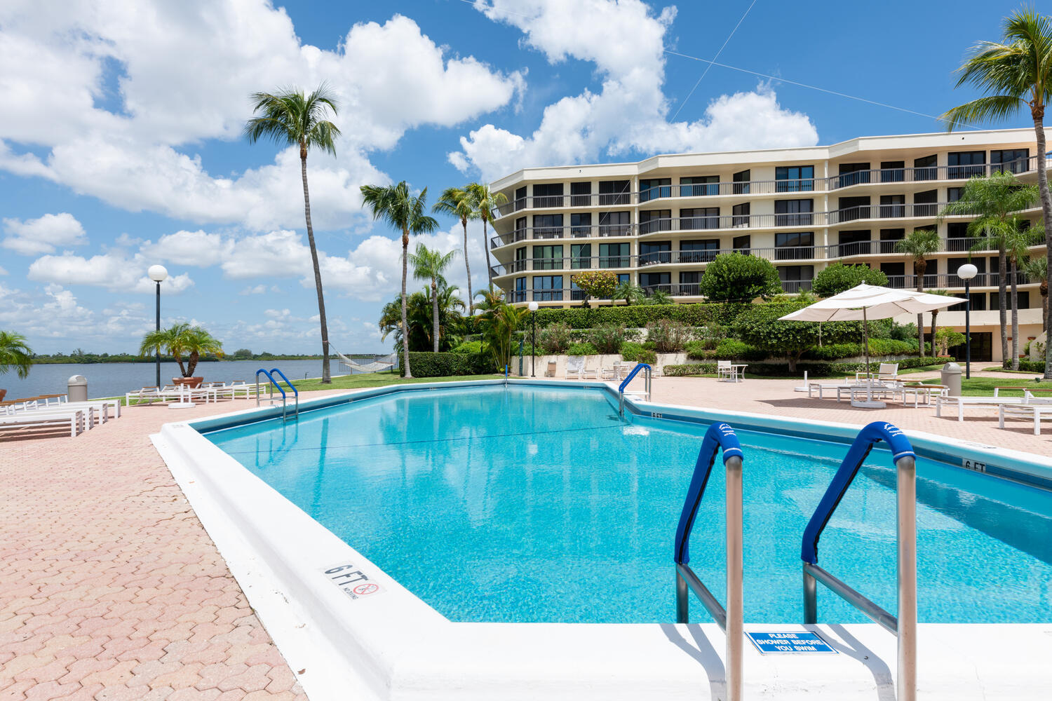 a view of swimming pool with outdoor seating and city view