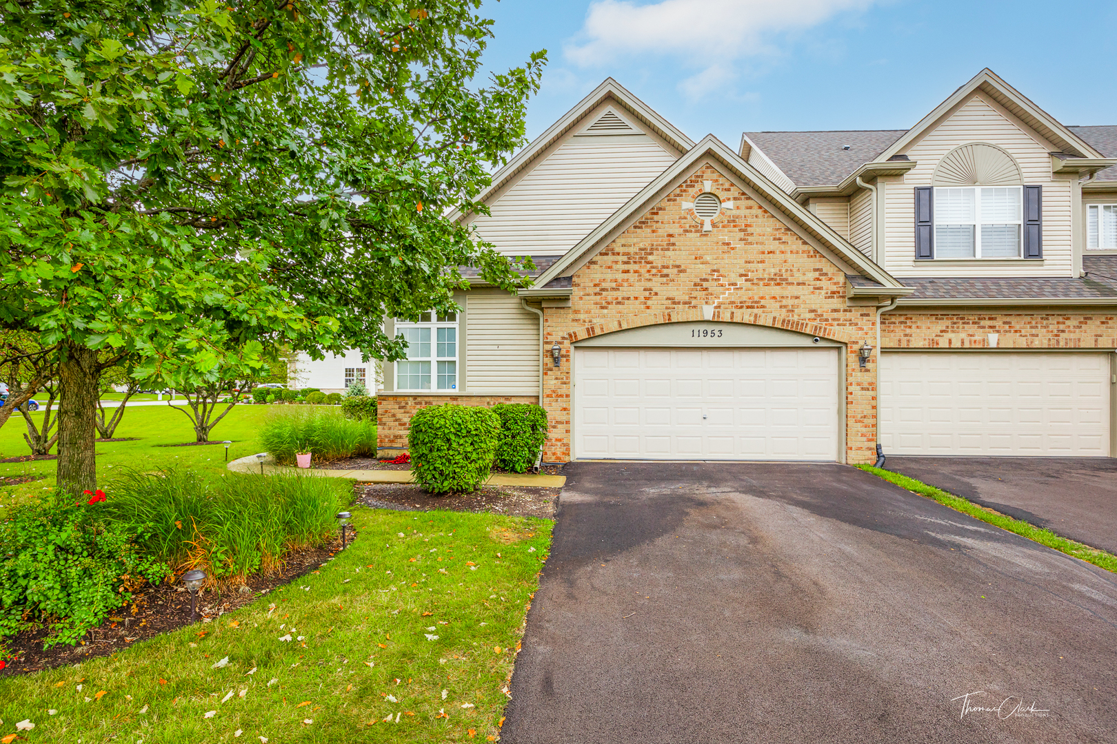 a view of front a house with a yard and garage