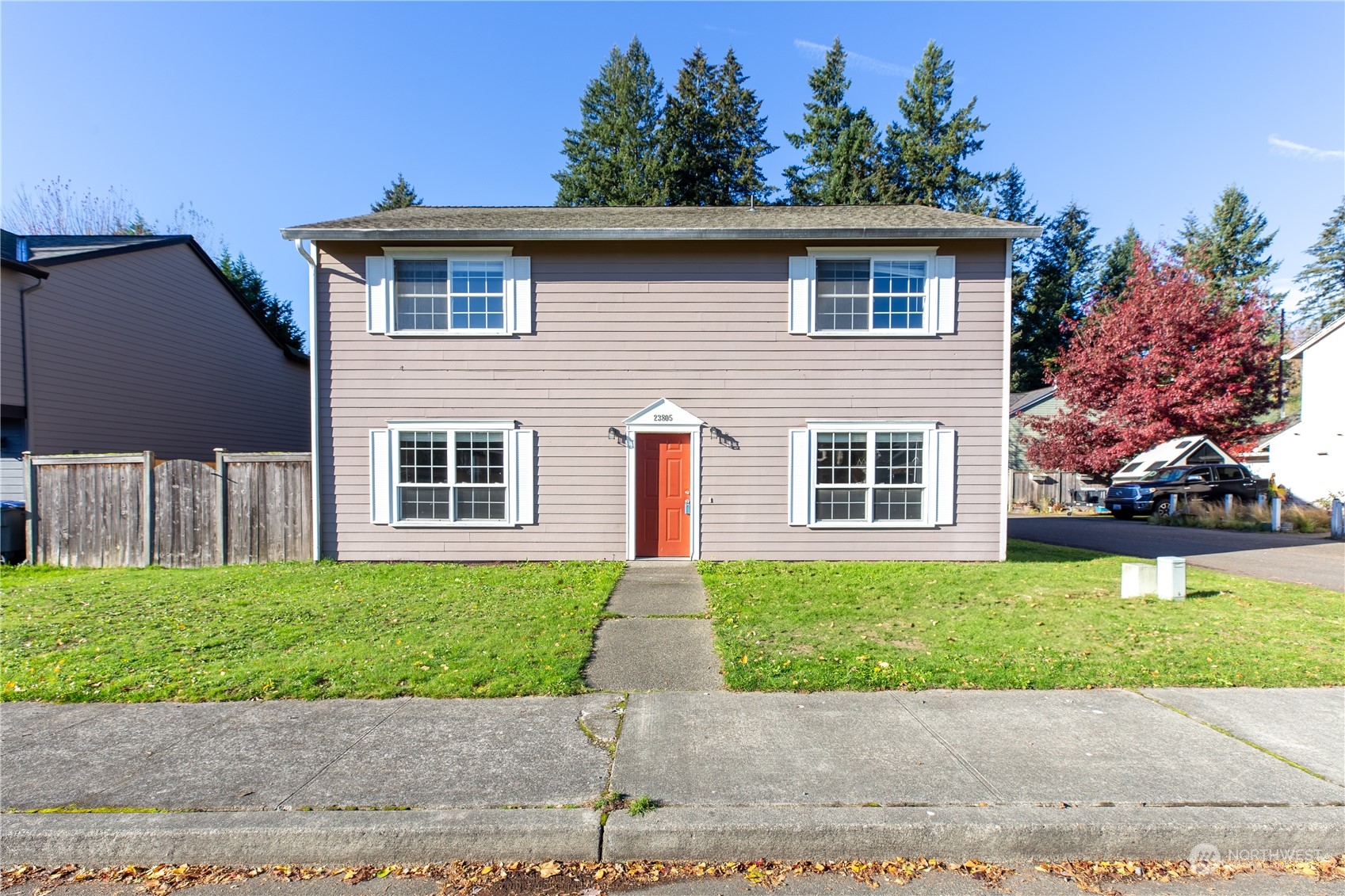 a front view of a house with a yard and a garage