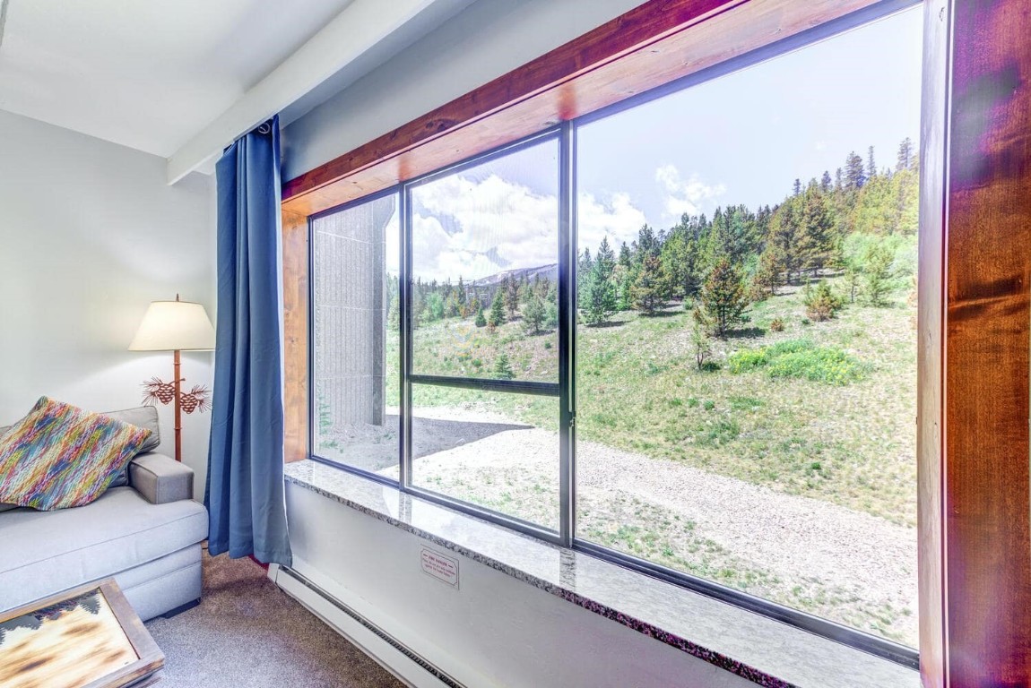 a view of a room with furniture and a large window