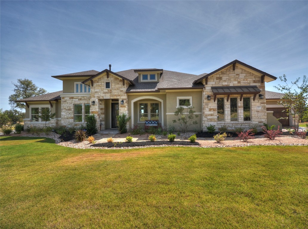 a front view of a house with swimming pool and yard