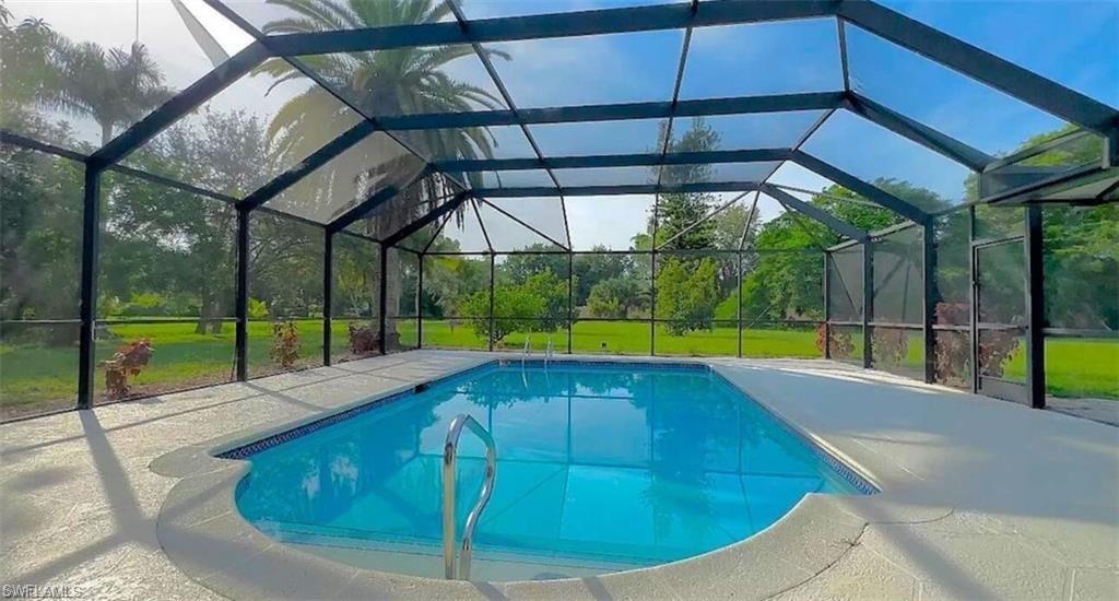 a view of a backyard with a swimming pool