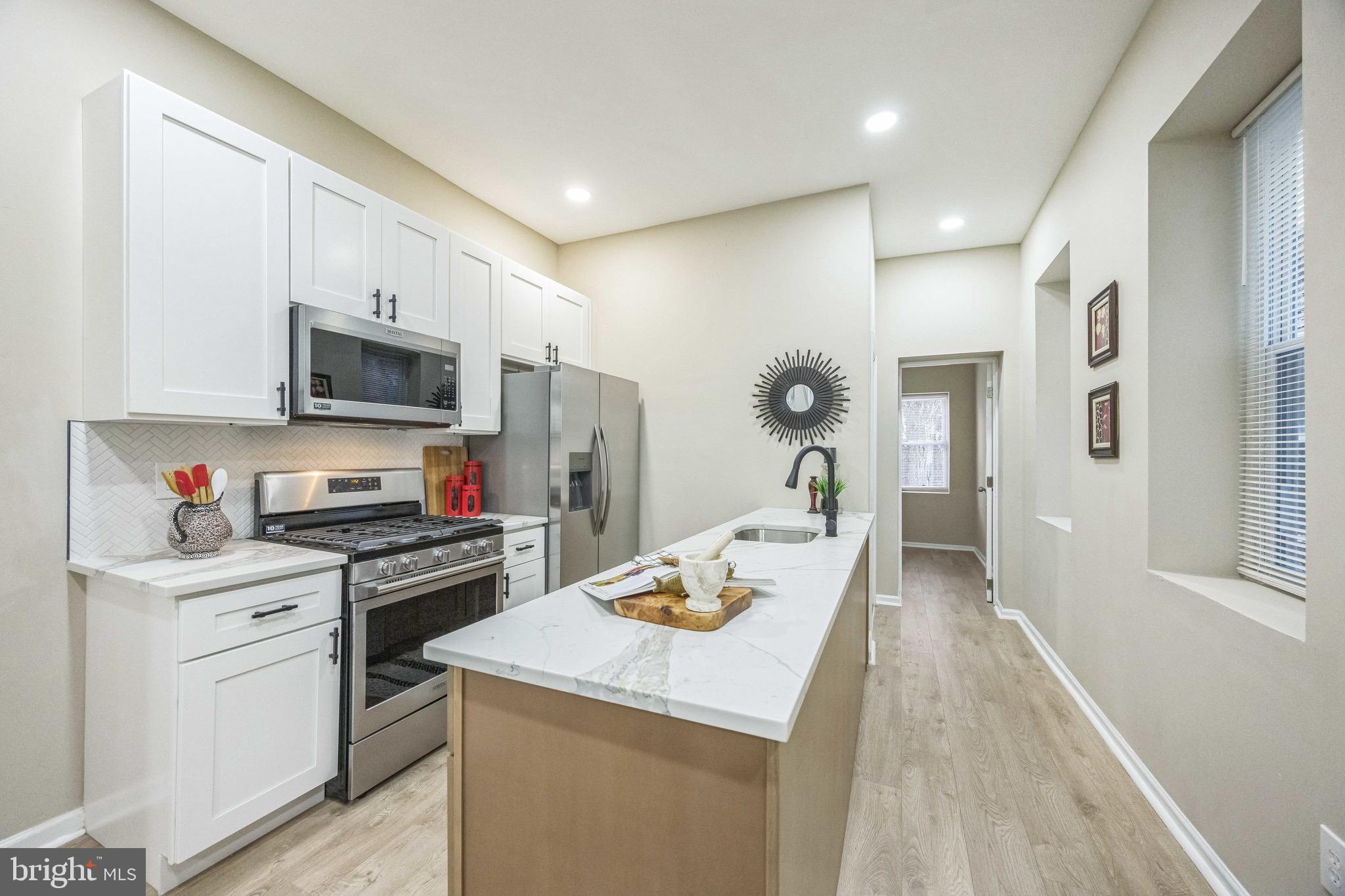 a kitchen with a sink a stove and refrigerator