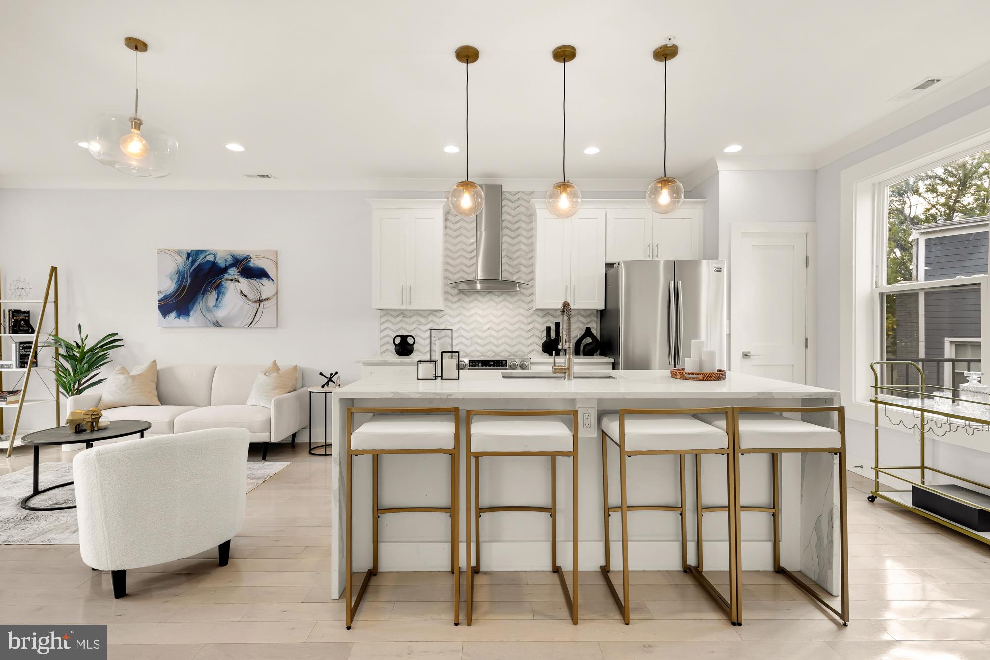 a very nice looking dining room with a kitchen island furniture and a chandelier