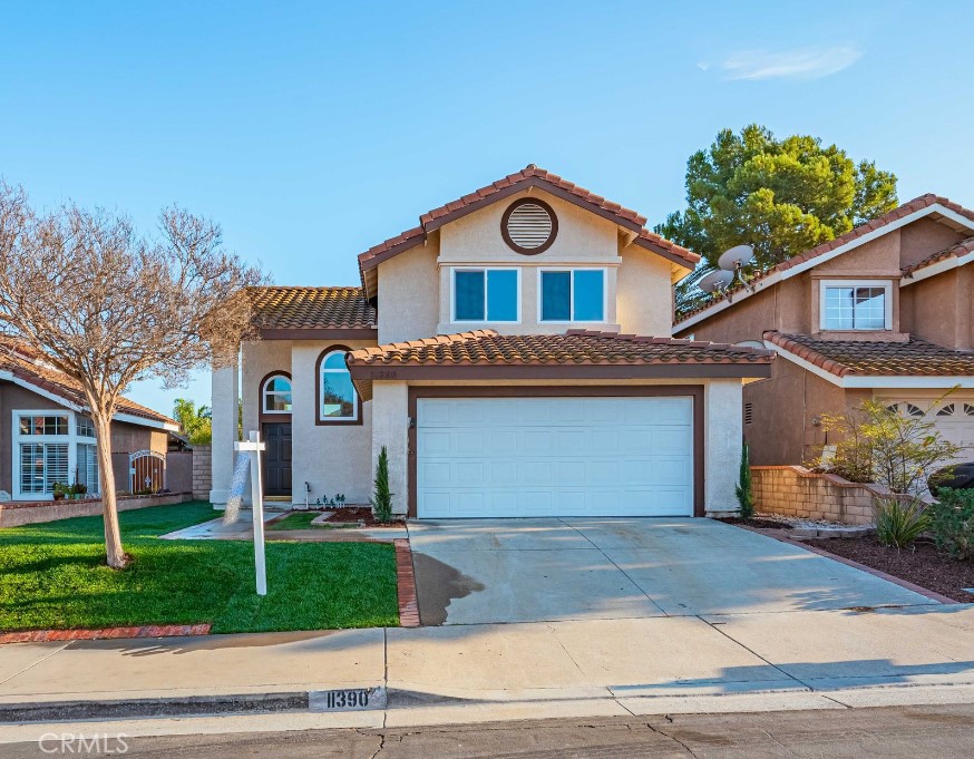 a view of a house with a yard and garage