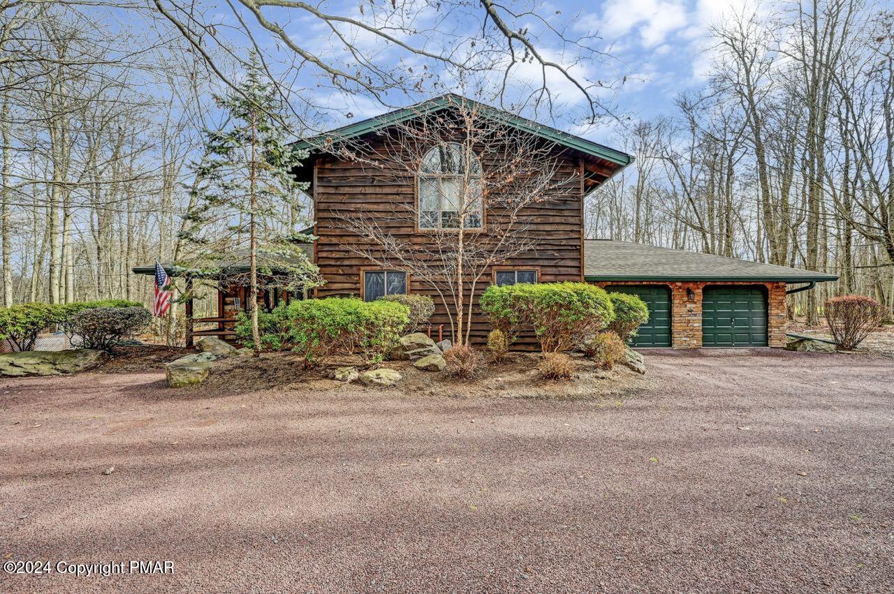 a view of a house with a yard and garage