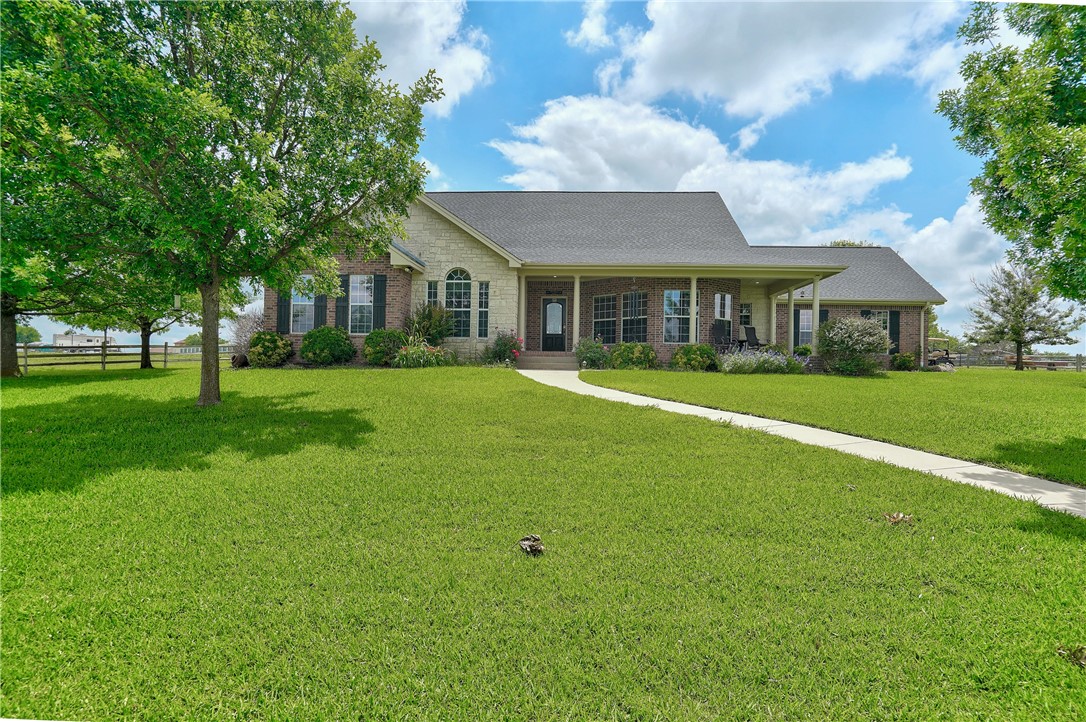 a front view of a house with a garden