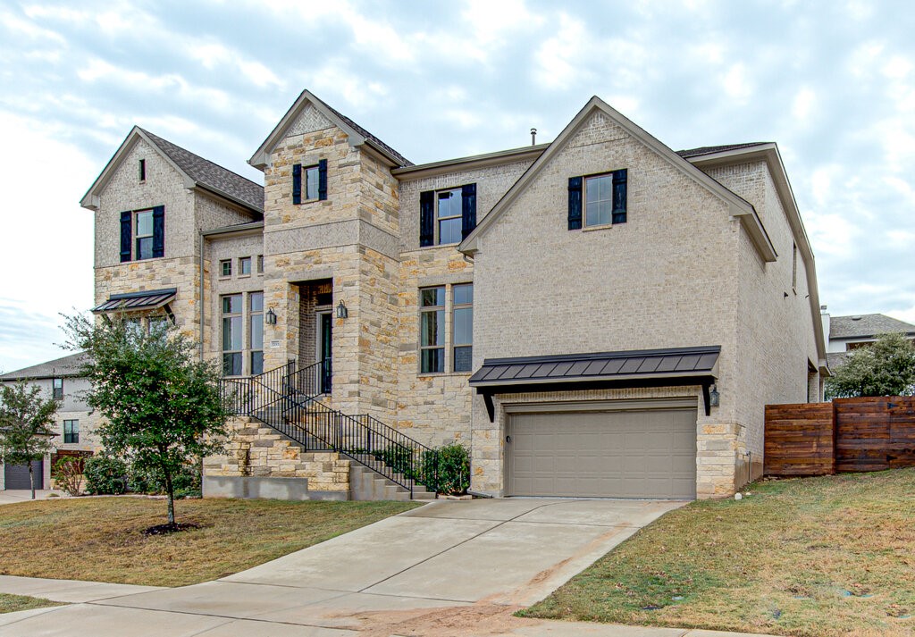 a front view of a house with a yard and garage