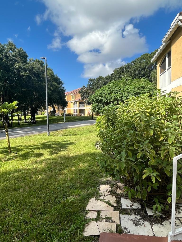 a view of a house with a backyard