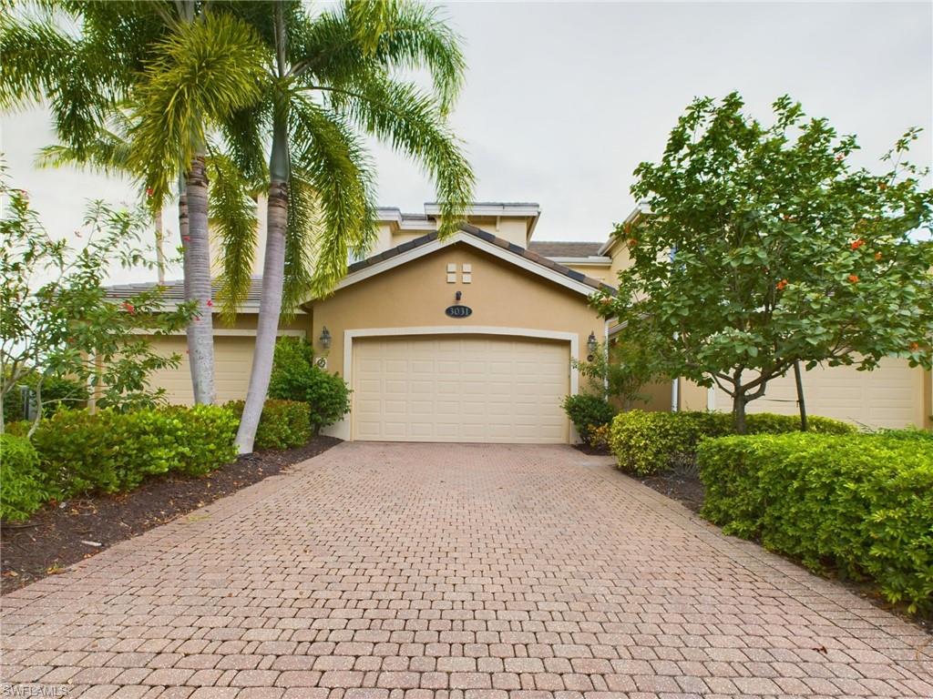 a view of a house with a yard and palm trees