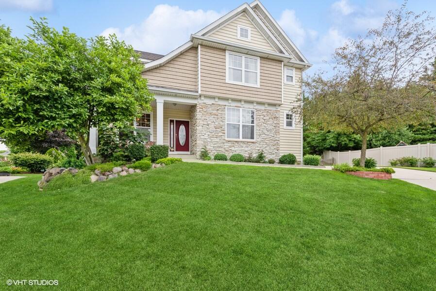 a front view of house with yard and green space