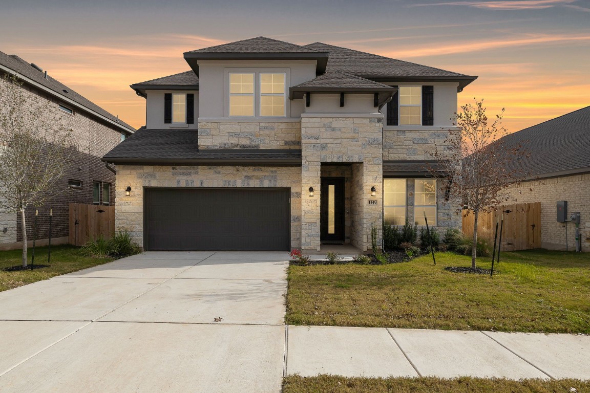 a front view of a house with a yard