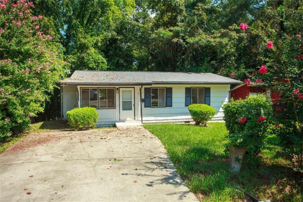 a front view of a house with a yard and porch