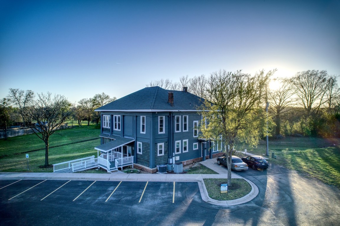 a view of a house with backyard porch and sitting area